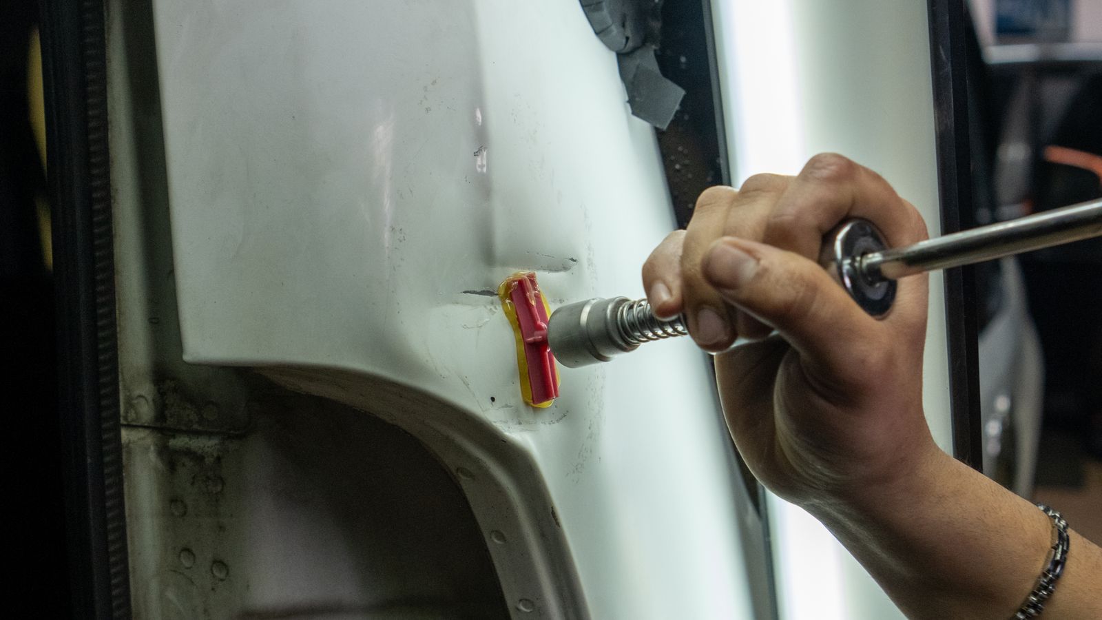Technician performing collision body repair